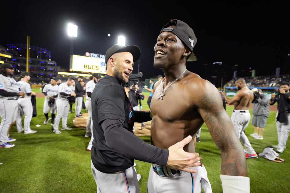 Miami Marlins' Jazz Chisholm Jr., right, celebrates with manager Skip Schumaker after clinching a playoff berth with a win over the Pittsburgh Pirates in a baseball game in Pittsburgh, Saturday, Sept. 30, 2023. (AP Photo/Gene J. Puskar)