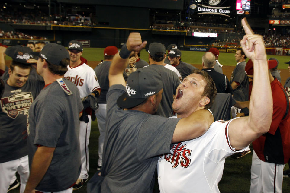 FILE - Arizona Diamondbacks' Sean Burroughs, right, and Gerardo Parra celebrate after the Diamondbacks defeated the San Francisco Giants in a baseball game to clinch the NL West division title, Sept. 23, 2011, in Phoenix. Burroughs, a two-time Little League World Series champion who won an Olympic gold medal and went on to a major league career that was interrupted by substance abuse, has died. He was 43. The Los Angeles County Medical Examiner’s online records said Burroughs died Thursday, May 9, 2024, with the cause of death deferred. (AP Photo/Ross D. Franklin, File)