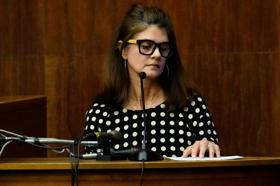 Christina Salito looks at a list of loans she gave her ex-boyfriend, Daniel Rochat (not shown), Wednesday March 27, 2024. Salito is the motive witness in the trial of Rochat who is accused of killing an East Rutherford real estate agent in 2012.