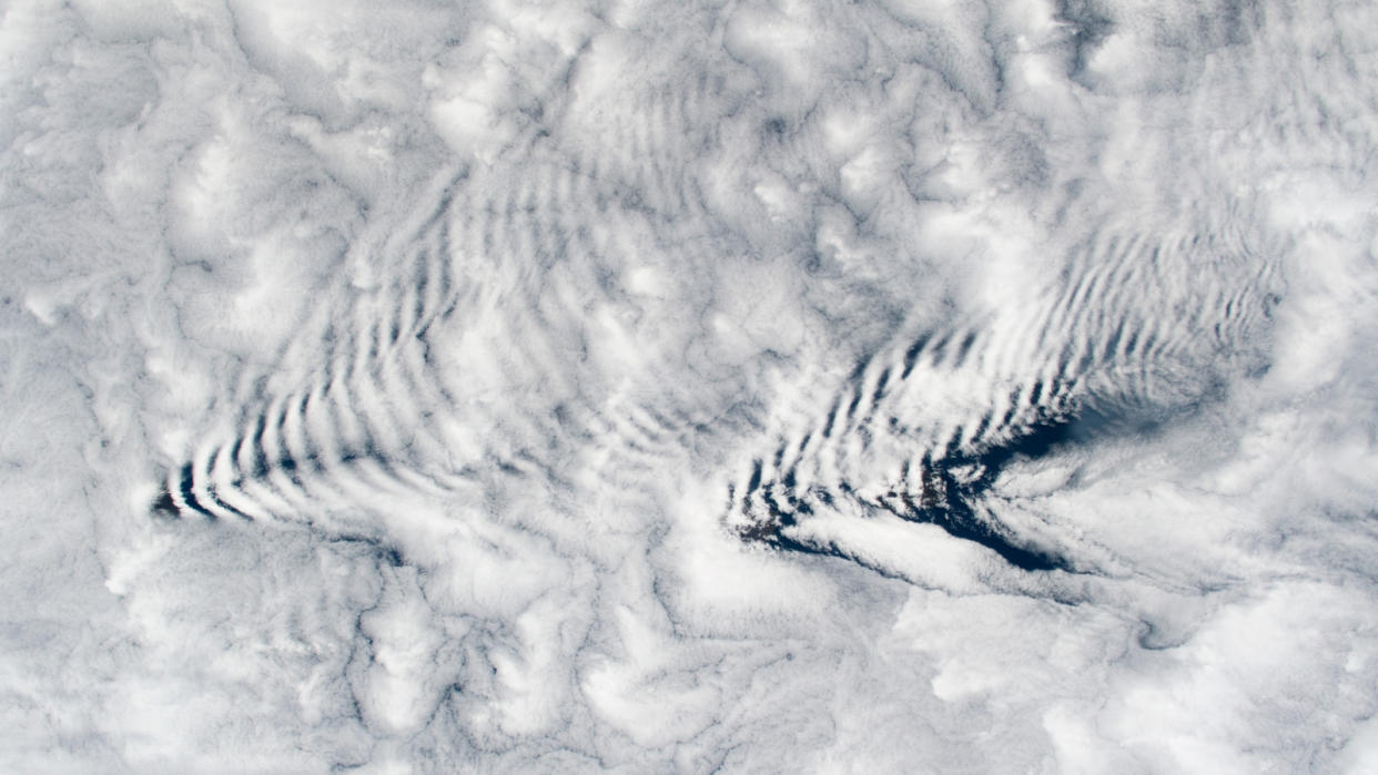  A pair of arrow-shape ripples in clouds as viewed from space. 