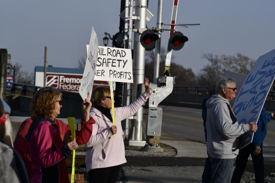 A group of protesters gather at West State and Front streets Wednesday near the railroad tracks to emphasize the need for improved rail safety.