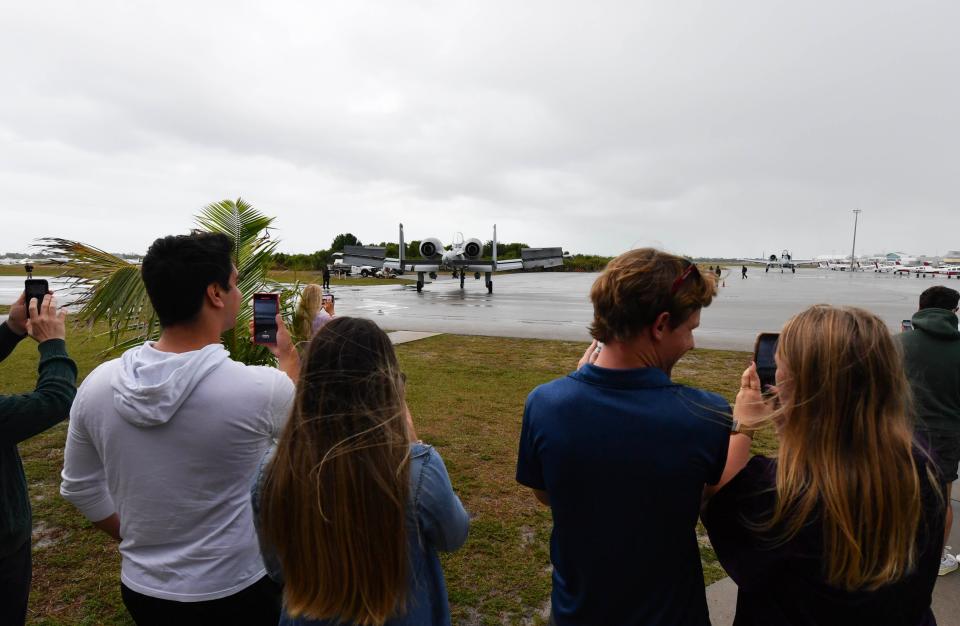 Spectators at the Florida Institute of Technology's Emil Buehler Center for Aviation Training and Research watch the U.S. Air Force A-10C Thunderbolt II Demonstration Team arrive on Wednesday, April 12, 2023.