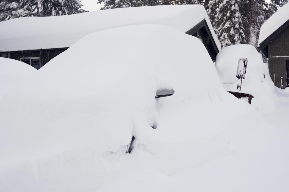 A vehicle is covered in snow during a storm, Sunday, March 3, 2024, in Truckee, Calif. (AP Photo/Brooke Hess-Homeier)