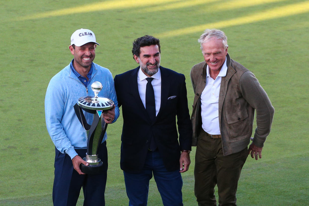 Charl Schwartzel poses for a photo with Yasir Al-Rumayyan, Saudi PIF governor, and Greg Norman, LIV Golf CEO, after winning the first LIV Golf event at The Centurion Club on June 11 in St. Albans, England. (Craig Mercer/MB Media/Getty Images)