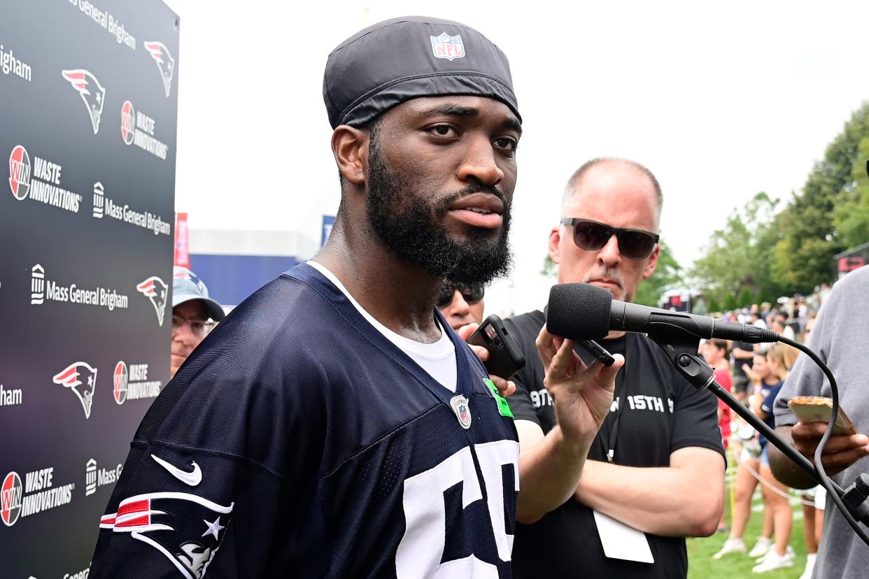 Josh Uche speaks to the media during last season's training camp.