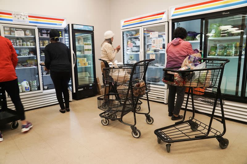 Community members pick out food at The Community Assistance Center food pantry, in Atlanta