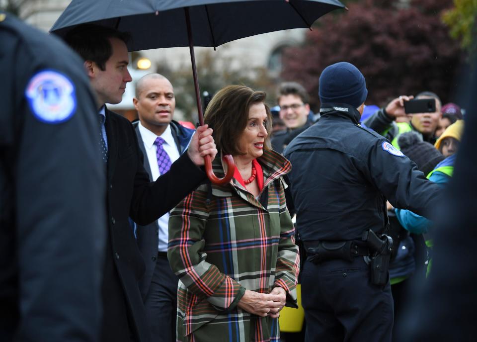 House Speaker Nancy Pelosi, D-Calif., making her way through the crowd in front of the Supreme Court building Tuesday as the court hears arguments on whether the 2017 Trump administration decision to end the Deferred Action for Childhood Arrivals program (DACA) is lawful.