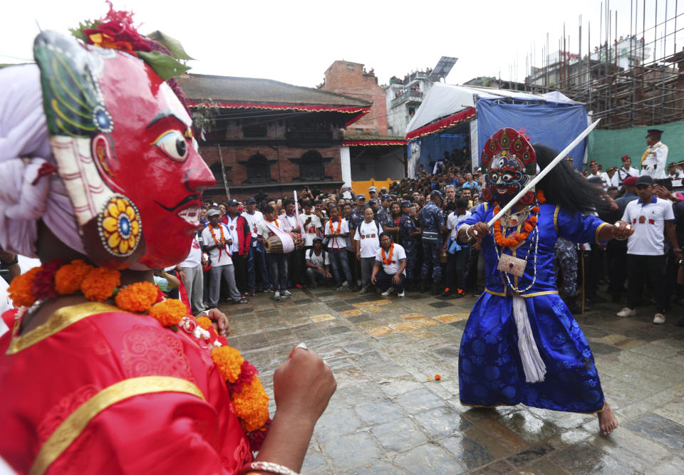 Masked dancers perform a traditional dance during Indra Jatra festival, an eight-day festival that honors Indra, the Hindu god of rain, in Kathmandu, Nepal, Friday, Sept. 13, 2019. During this festival, families gather for feasts and at shrines to light incense for the dead, and men and boys in colorful masks and gowns representing Hindu deities dance to the beat of traditional music and devotees' drums, drawing tens of thousands of spectators to the city's old streets. (AP Photo/Niranjan Shrestha)