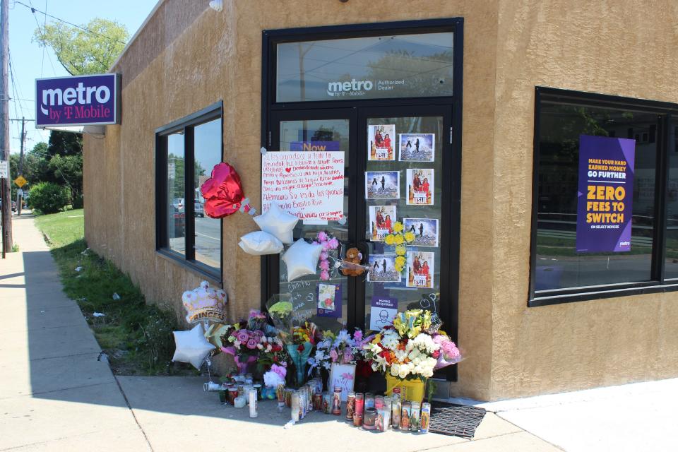 Signs, photos, candles and balloons adorn the entrance of the Metro by T-Mobile store in Elsmere in remembrance of Leslie Lizet Basilio, 28, on Tuesday, May 18, 2021.