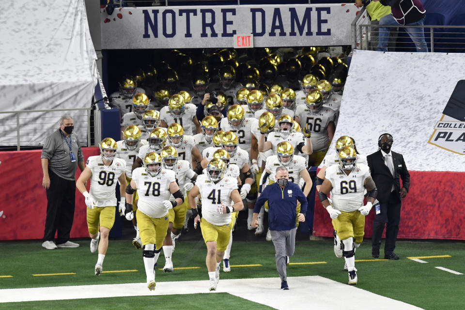 ARLINGTON, TEXAS - JANUARY 01: Head coach Brian Kelly and the Notre Dame Fighting Irish football players run on the field during player introductions before the College Football Playoff Semifinal at the Rose Bowl football game against the Alabama Crimson Tide at AT&T Stadium on January 01, 2021 in Arlington, Texas. The Alabama Crimson Tide defeated the Notre Dame Fighting Irish 31-14. (Photo by Alika Jenner/Getty Images)