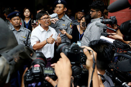 Detained and handcuffed Reuters journalist Wa Lone speaks to media after a court hearing in Yangon, Myanmar May 2, 2018. REUTERS/Ann Wang