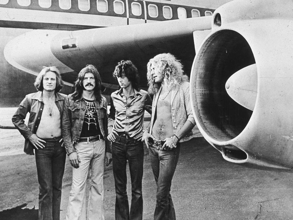 From left to right: John Paul Jones, John Bonham, Jimmy Page, and Robert Plant pose in front of The Starship during their 1973 tour.