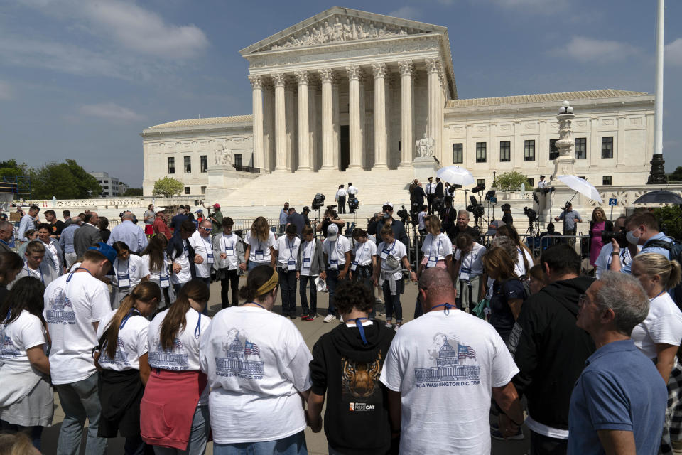 People pray outside of the U.S. Supreme Court Tuesday, May 3, 2022 in Washington. A draft opinion suggests the U.S. Supreme Court could be poised to overturn the landmark 1973 Roe v. Wade case that legalized abortion nationwide, according to a Politico report released Monday. Whatever the outcome, the Politico report represents an extremely rare breach of the court's secretive deliberation process, and on a case of surpassing importance. (AP Photo/Jose Luis Magana)