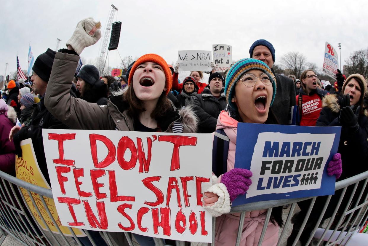 Demonstrators hold signs during a 
