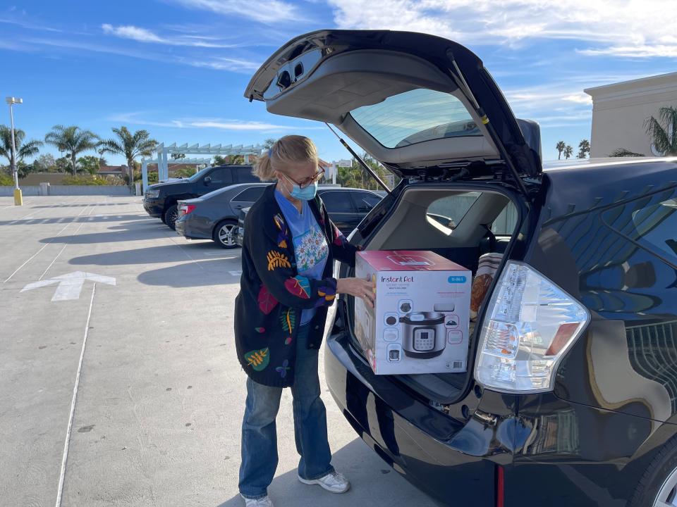 Kathy Trigueiro loads her car with a Black Friday deal at Pacific View mall in Ventura on Friday morning, Nov. 26, 2021.