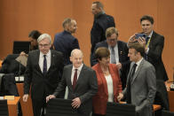 German Chancellor Olaf Scholz, front, and French President Emmanuel Macron, front right, arrive at the G20 Investment Summit - German Business and the CwA Countries on the sidelines of a Compact with Africa in Berlin, Germany, Monday, Nov. 20, 2023. In the high-level conference investment summit the African Compact partner countries meet with high-ranking representatives of German companies to explore investments under the framework of the G20 partnership with Africa. (AP Photo/Markus Schreiber, Pool)