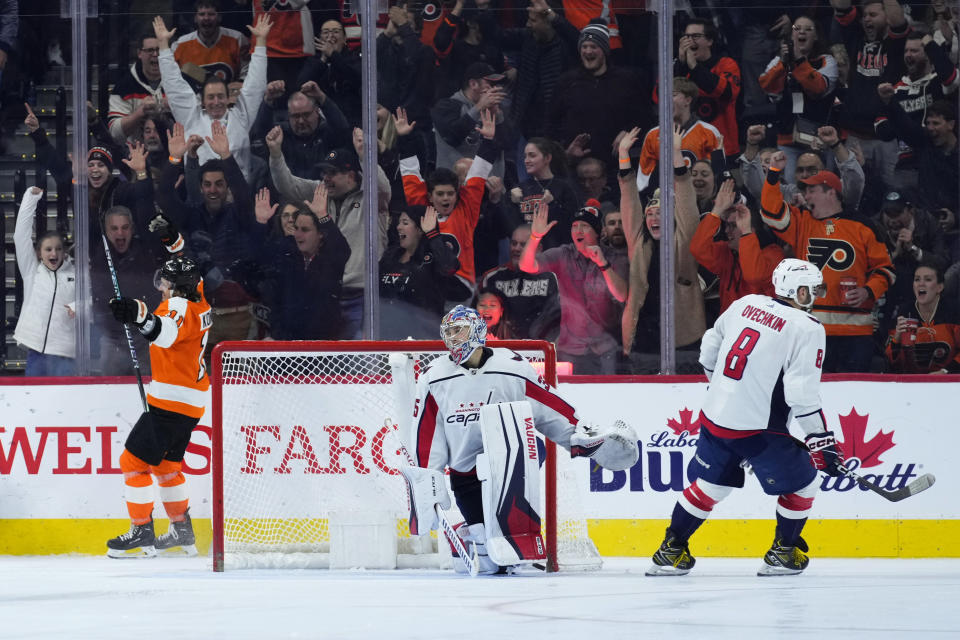 Philadelphia Flyers' Travis Konecny (11) celebrates after scoring a goal past Washington Capitals' Darcy Kuemper (35) and Alex Ovechkin (8) during the third period of an NHL hockey game, Wednesday, Jan. 11, 2023, in Philadelphia. (AP Photo/Matt Slocum)