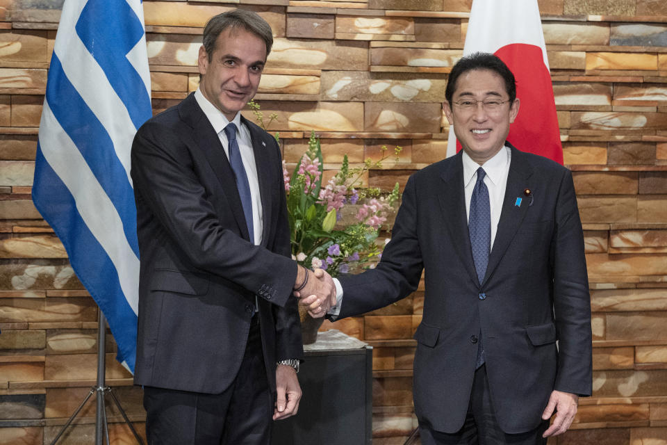 Greek Prime Minister Kyriakos Mitsotakis, left, is welcomed by Japanese Prime Minister Fumio Kishida upon his arrival ahead of their meeting at the prime minister's official residence in Tokyo on Monday, Jan. 30, 2023. (Richard A. Brooks/Pool Photo via AP)