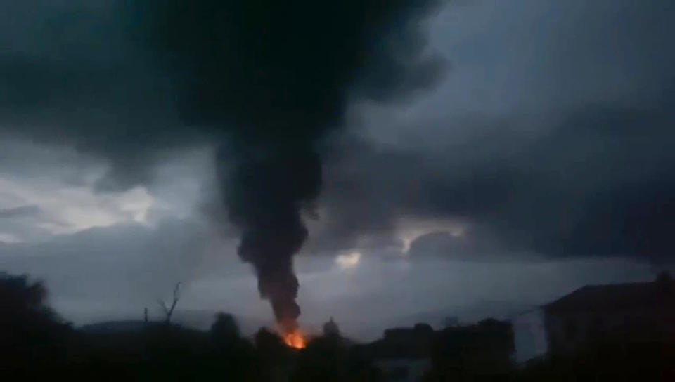 This grab taken from video distributed by Siranush Sargsyan's Twitter account on Monday, Sept. 25, 2023, shows smoke rising after a fuel depot explosion near Stepanakert, Nagorno-Karabakh. Several dozen people were injured on Monday night at a gas station just outside of the breakaway region's capital, Stepanakert, where a fuel tank exploded. Dozens of people were lining up at the gas station at the time to fuel their cars in order to move to Armenia. (Siranush Sargsyan's Twitter account via AP)