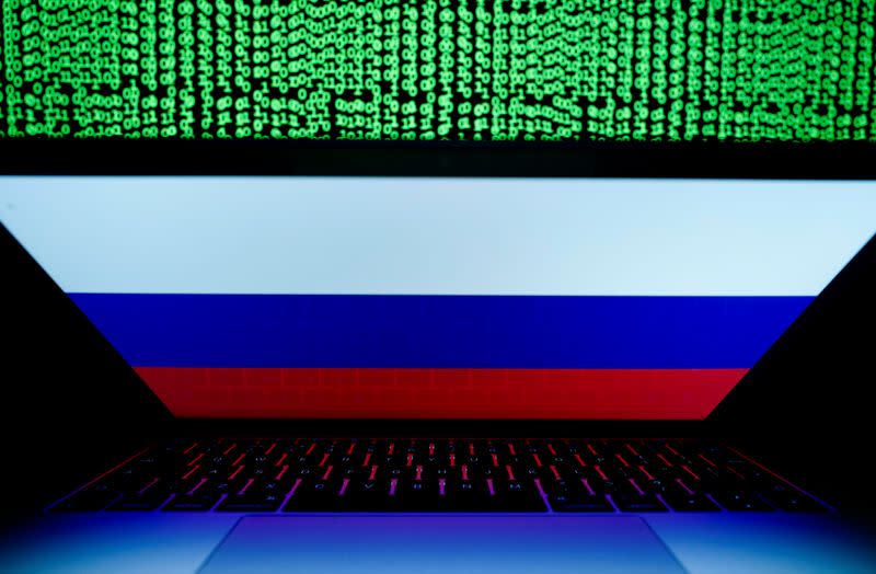 FILE PHOTO: Russian flag is seen on the laptop screen in front of a computer screen on which cyber code is displayed, in this illustration picture