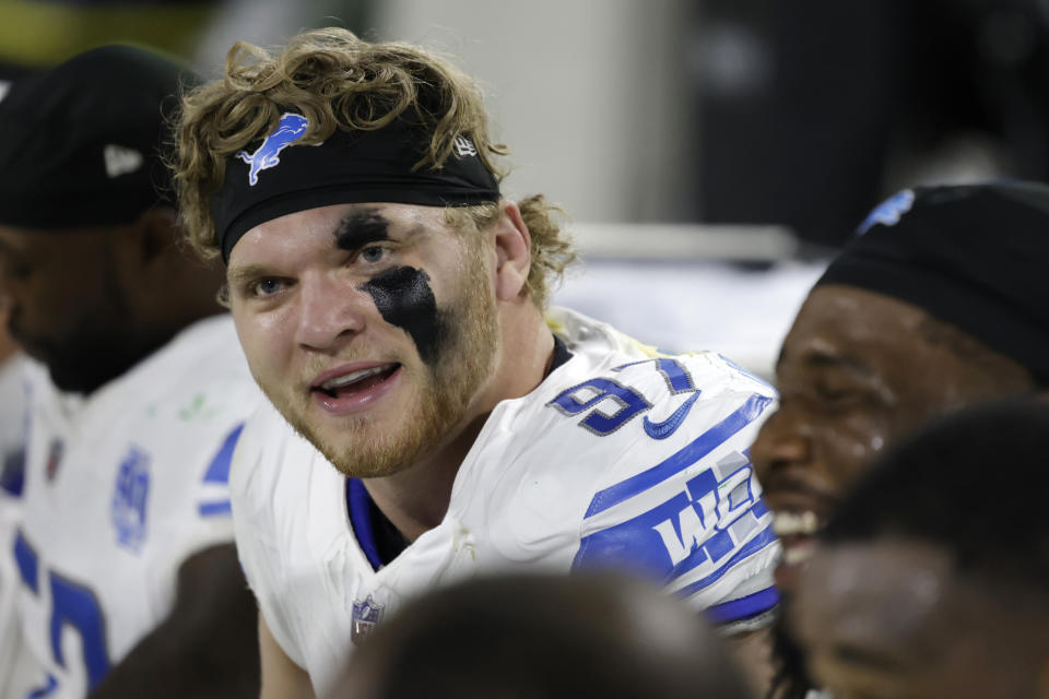 Detroit Lions defensive end Aidan Hutchinson (97) sits on the bench during the first half of an NFL football game against the Green Bay Packers, Thursday, Sept. 28, 2023, in Green Bay, Wis. (AP Photo/Matt Ludtke)