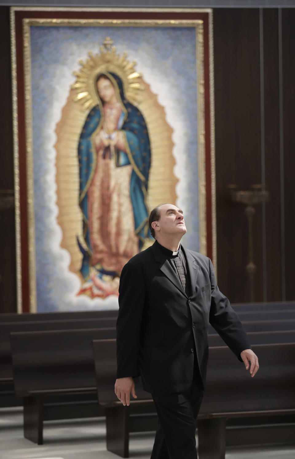 Father Darrin Merlino, of the Claretian Missionaries, walks past an image of the Virgin of Guadalupe, inside of the newly renovated Christ Cathedral Monday, July 8, 2019, in Garden Grove, Calif. The 88,000-square-foot Catholic church has undergone a $77 million renovation. (AP Photo/Marcio Jose Sanchez)