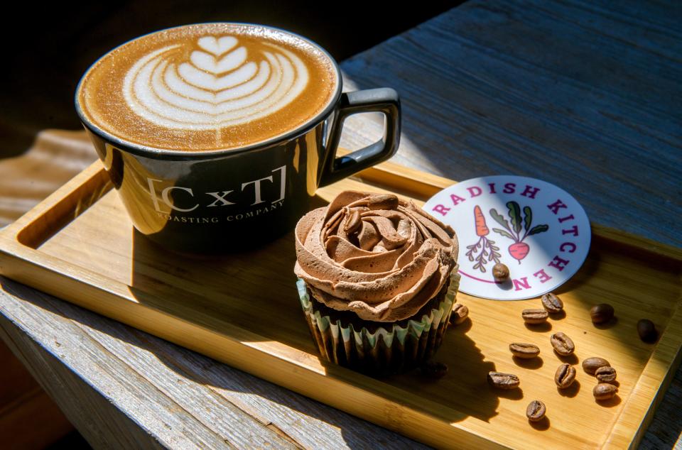 [CxT] Roasting Company has teamed up with Radish Kitchen in Campustown to offer vegan, gluten-free cupcakes, donuts and other baked sweets to coffee lovers at Keller Station. Shown is a [CxT] mocha latté and a Radish Kitchen chocolate coffee cupcake.