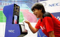 NEC Red Rockets' volleyball player Haruyo Shimamura demonstrates the face recognition system for Tokyo 2020 Olympics and Paralympics, which is developed by NEC corp, in Tokyo, Japan August 7, 2018. REUTERS/Toru Hanai