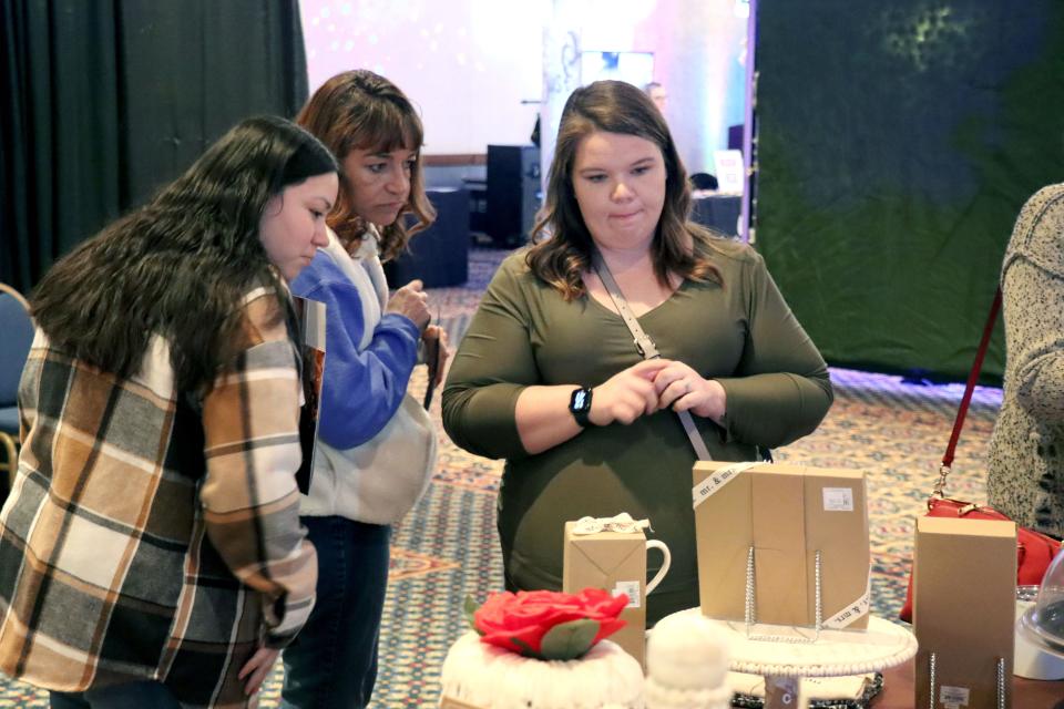 Alexis Salas, Amber Goheen and Heather Soltero look at the displays at the 2023 Amarillo Bridal Show held at the Amarillo Civic Center Sunday afternoon.