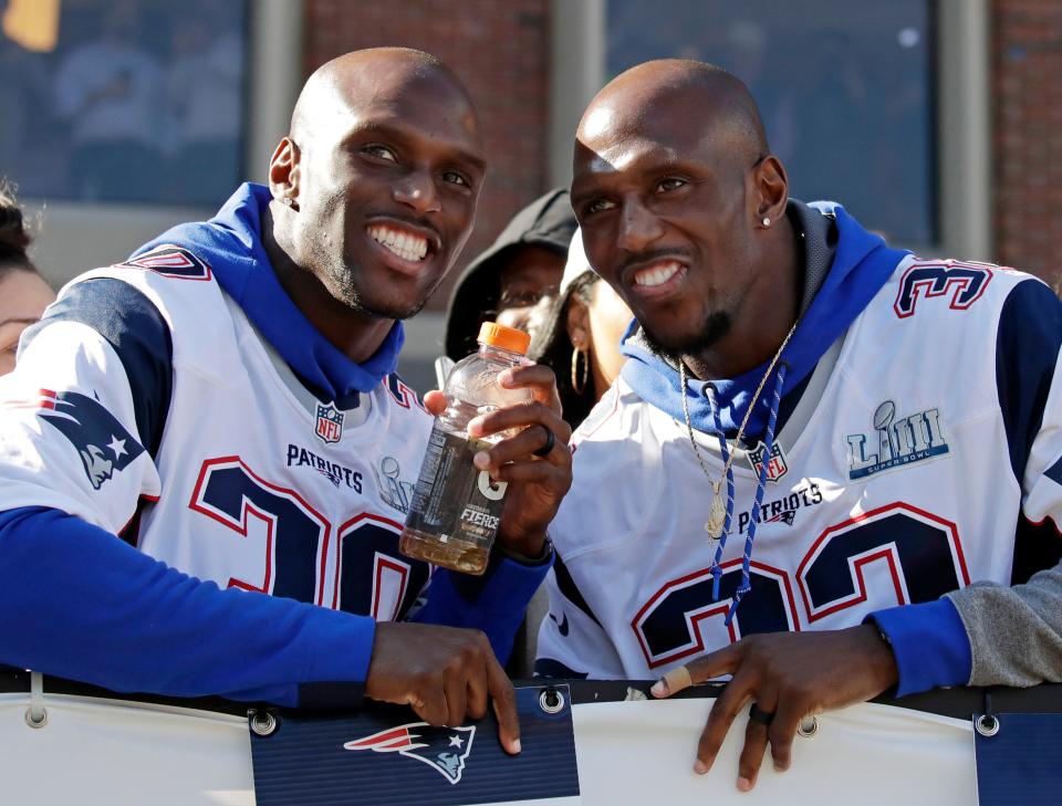 Jason McCourty, left, and Devin McCourty celebrate during the victory parade through downtown Boston to celebrate their win over the Los Angeles Rams in Super Bowl 53.