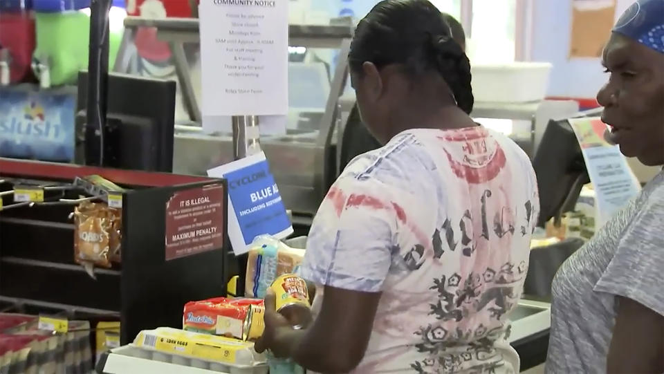 This image made from a video, shows people shopping for groceries in Broome, Australia Wednesday, April 12, 2023. Miners, cattle ranchers, tourists and Indigenous locals were evacuating from Australia’s remote northwest coast on Wednesday as an intensifying tropical cyclone approached. (Australian Broadcasting Corporation via AP)