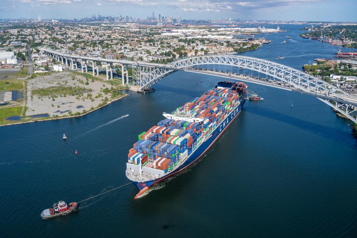 On a stop at the Elizabeth-Port Authority Marine Terminal, tug boats helped the CMA CGM Brazil cargo ship navigate the Kill Van Kull beneath the Bayonne Bridge.