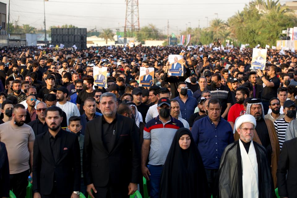 Supporters of a political movement called "Harakat Huqooq, Arabic for Rights Movement, listen to Hussein Muanis speak during an election rally in Baghdad, Iraq, Friday, Sept. 3, 2021. Muanis is the leader of Kataeb Hezbollah, one of the most hard-line and powerful militias with close ties to Iran, who once battled U.S. troops. He is the first to be openly affiliated with Kataeb Hezbollah or Hezbollah Brigades, signaling the militant group’s formal entry into politics. (AP Photo/Hadi Mizban)