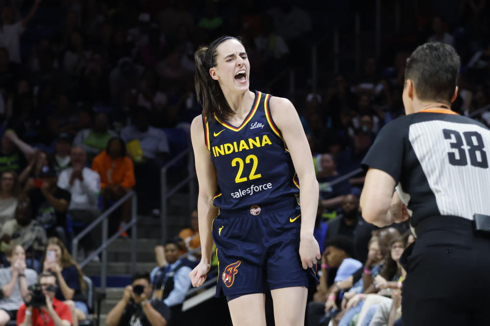 CORRECTS FROM CAITLYN TO CAITLIN - Indiana Fever guard Caitlin Clark (22) reacts after making a three-point shot against the Dallas Wings during the first half of an WNBA basketball game in Arlington, Texas, Friday, May 3, 2024. (AP Photo/Michael Ainsworth)