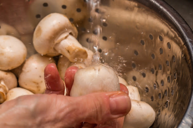 Cleaning mushrooms before freezing<p>iStock</p>