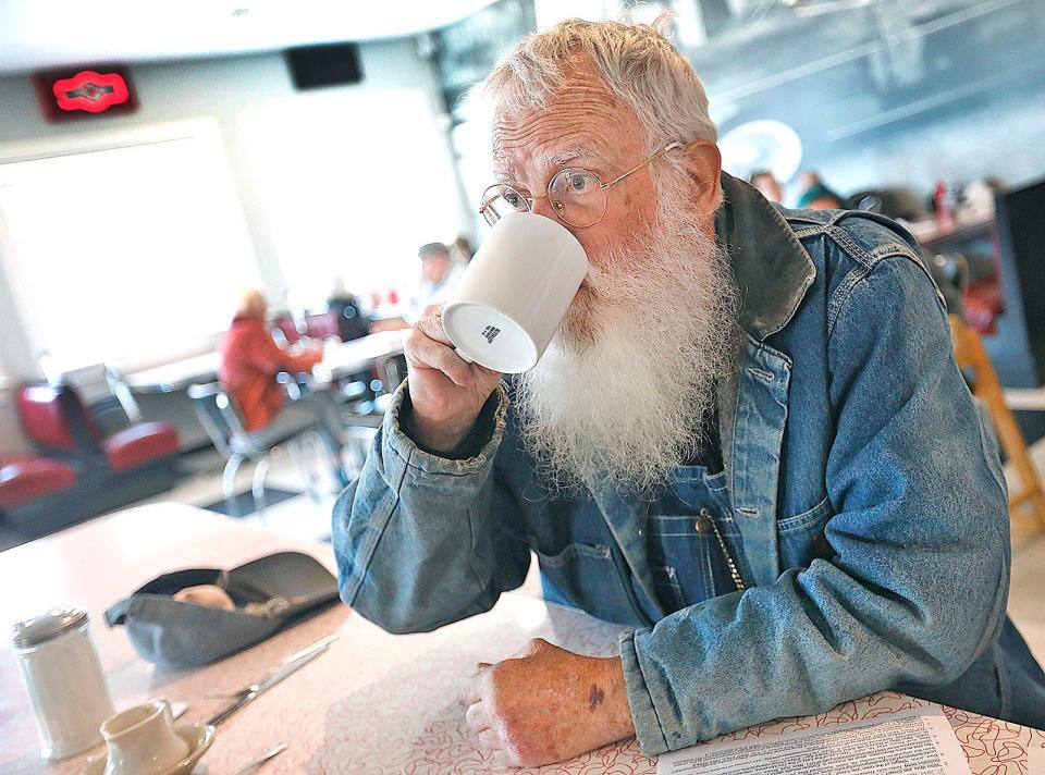 George Greenamyer, of Marshfield, enjoys a cup of coffee at the Brant Rock Hop in Marshfield.