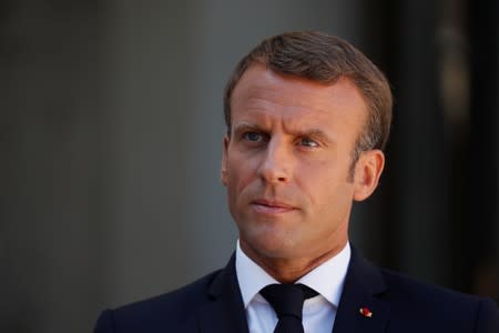 French President Emmanuel Macron delivers a joint statement with British Prime Minister Boris Johnson before a meeting on Brexit at the Elysee Palace in Paris