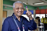 Former Malaysian Prime Minister and Gerakan Tanah Air (Homeland Party) chairman Minister Mahathir Mohamad shows his finger that is marked in ink after voting for the general election in Alor Setar, Kedah, Malaysia, Saturday, Nov. 19, 2022. Malaysians have begun casting ballots in a tightly contested national election that will determine whether the country’s longest-ruling coalition can make a comeback after its electoral defeat four years ago. (AP Photo/JohnShen Lee)