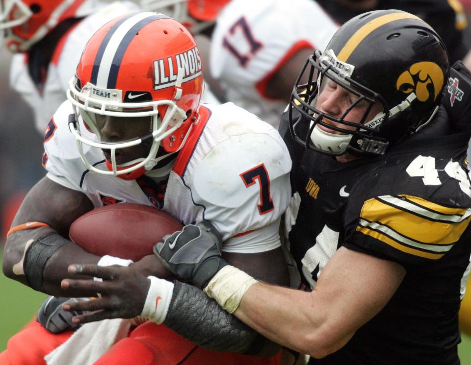 Former University of Iowa linebacker Mike Humpal (right) brings down Illinois quarterback Juice Williams during a game in 2007. Humpal had a career day with 18 tackles.