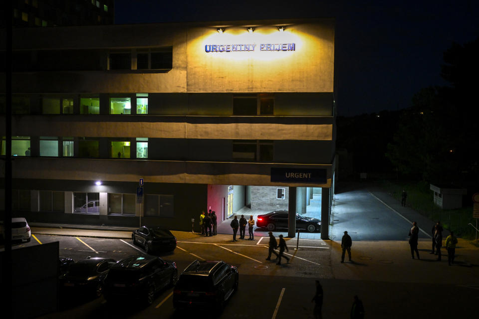 Police and officials stand outside the entrance of the emergency room of the F. D. Roosevelt University Hospital, where Slovak Prime Minister Robert Fico, who was shot and injured, is treated in Banska Bystrica, central Slovakia, Wednesday, May 15, 2024. Slovak Prime Minister Robert Fico is in life-threatening condition after being wounded in a shooting after a political event Wednesday afternoon, according to his Facebook profile.(AP Photo/Denes Erdos)