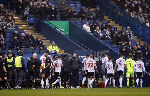 Players were removed from the pitch after the match was abandoned 