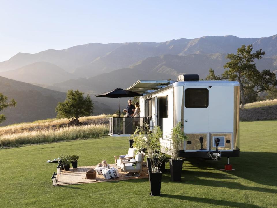 the 2022 Living Vehicle trailer outside on a patch of grass with an outdoor setup