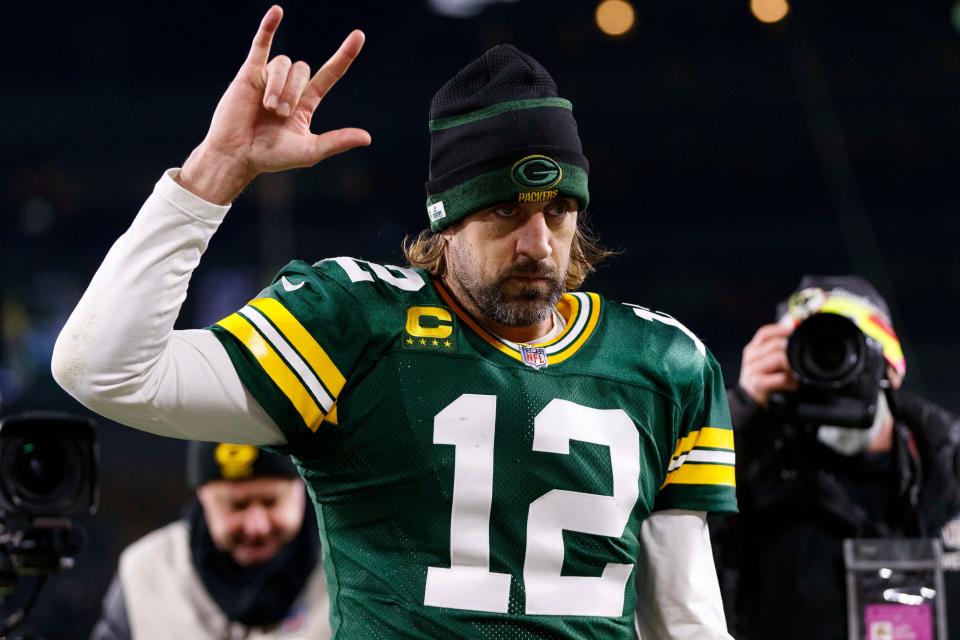 Aaron Rodgers walks off the field after a 2021 game.