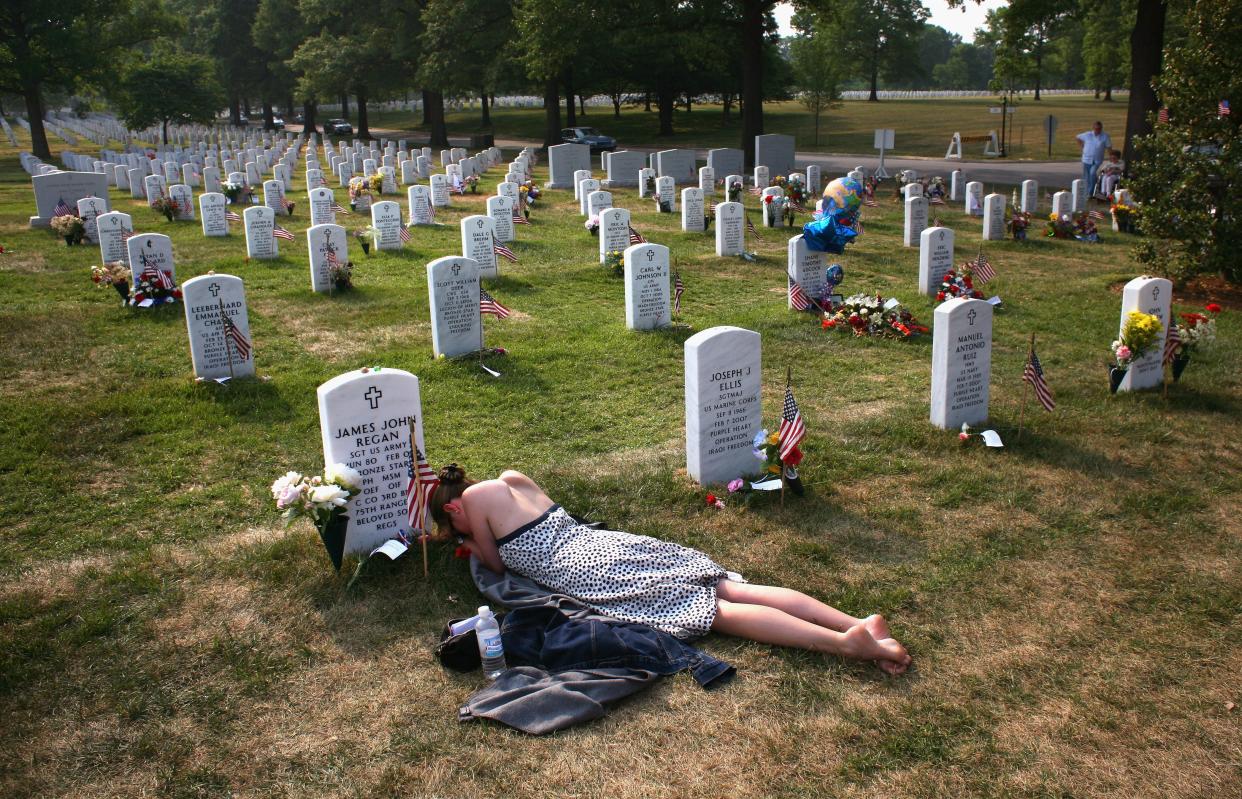 Mary McHugh mourns her slain fiance Sgt. James Regan at "Section 60" of the Arlington National Cemetery May 27, 2007. Regan, a U.S. Army Ranger, was killed by an IED explosion in Iraq in February2007, and this was the first time McHugh had visited the grave since the funeral. Section 60 is the resting place for many U.S. soldiers killed in Iraq and Afghanistan.