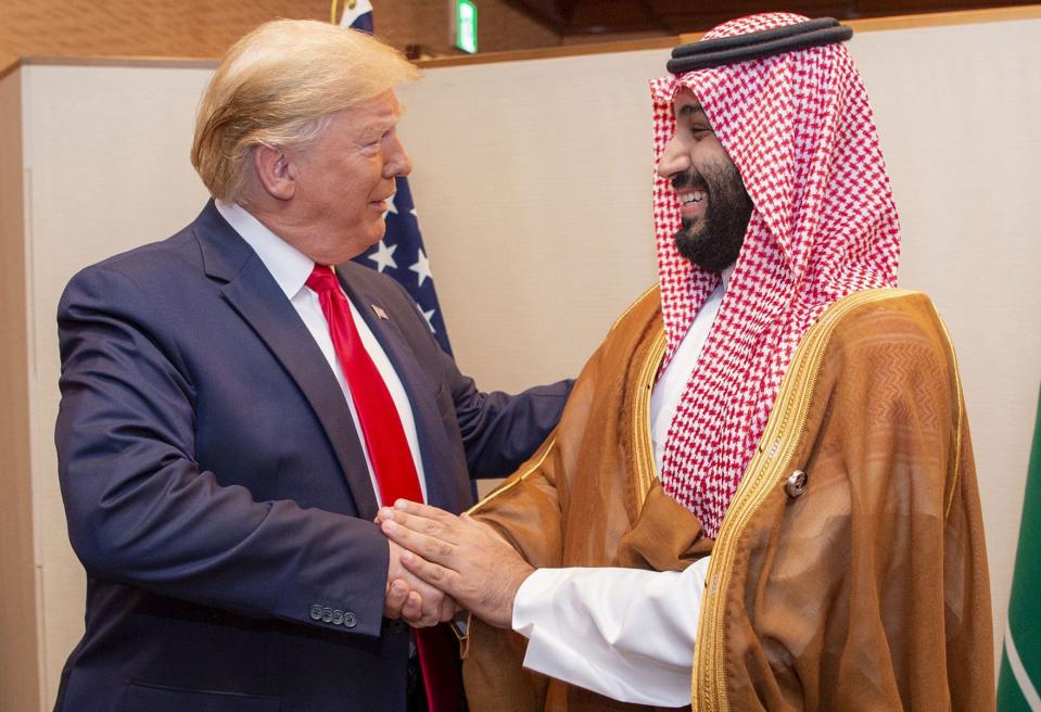 A handout picture provided by the Saudi Royal Palace on June 29, 2019, shows Saudi Crown Prince Mohammed bin Salman shaking hands with US President Donald Trump during their meeting on the sidelines of the G20 Summit in Osaka, Japan. 