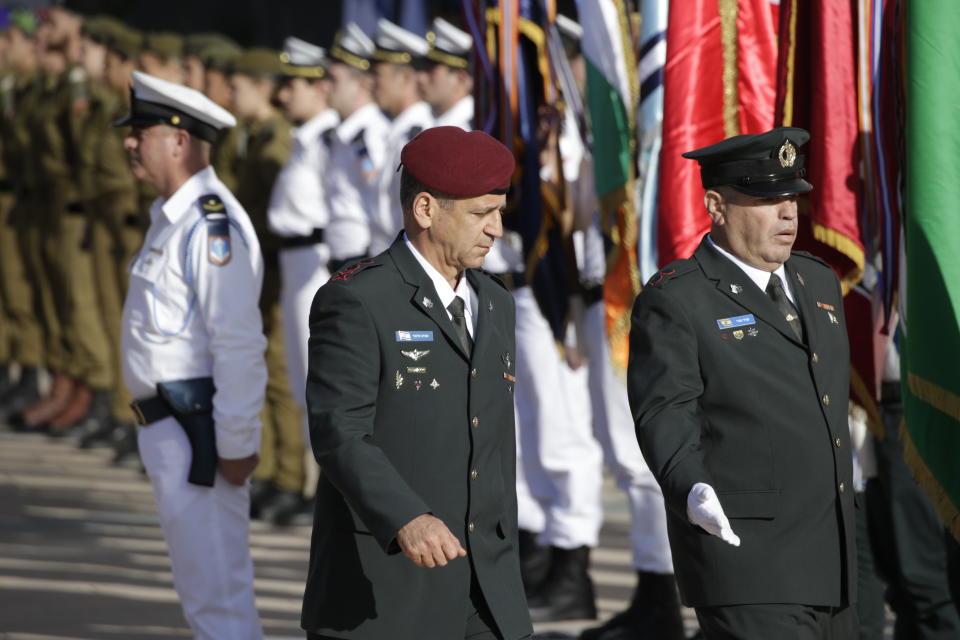 New Israeli Chief of Staff Lt. Gen. Aviv Kochavi, center, reviews an honor guard in Tel Aviv, Israel, Tuesday, Jan. 15, 2019. Kochavi pledged Tuesday to lead a "lethal, efficient and innovative army" as it faces what he said were grave challenges along its borders. (AP Photo/Ariel Schalit)