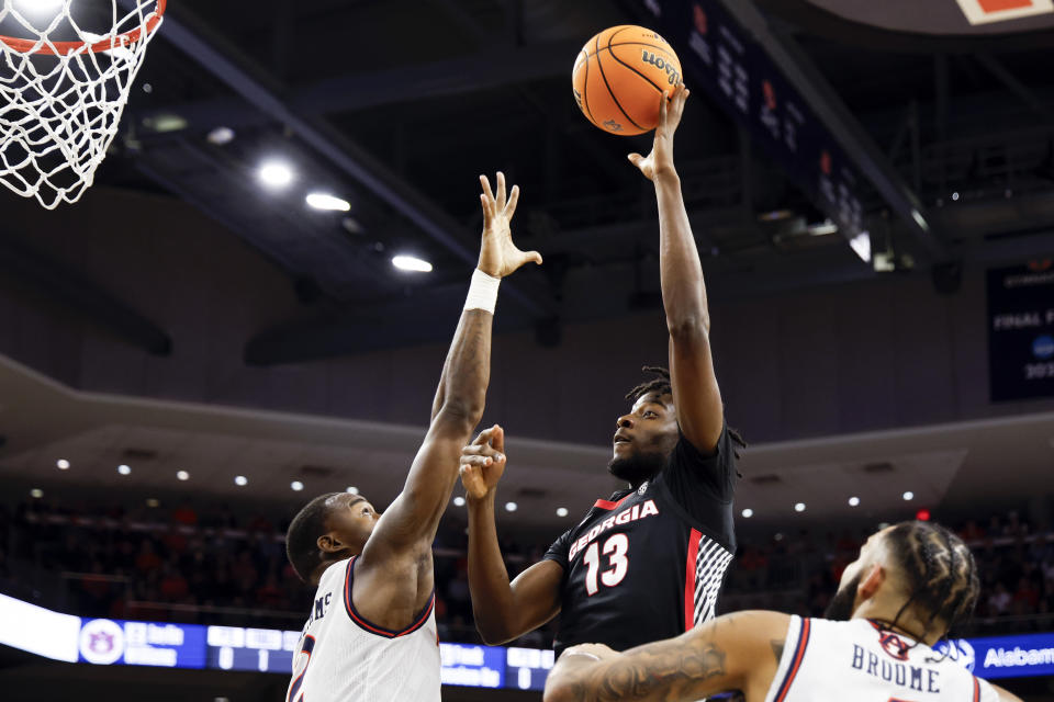 Georgia forward Dylan James (13) shoots over Auburn forward Jaylin Williams, left, during the first half of an NCAA college basketball game Saturday, March 9, 2024, in Auburn, Ala. (AP Photo/ Butch Dill)