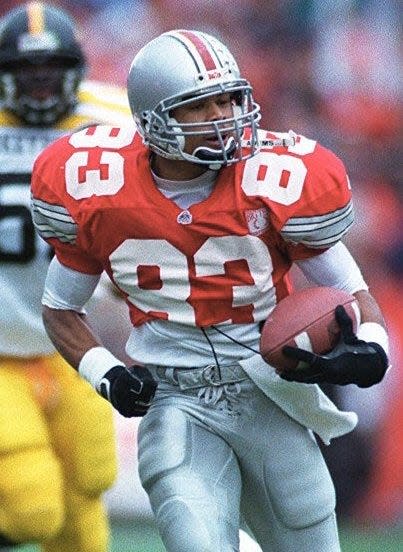 OSU's Terry Glenn is accompanied by Rickey Dudley on his way to a TD after a completion in the first half to make it 27-0 against Iowa. Russell Photo