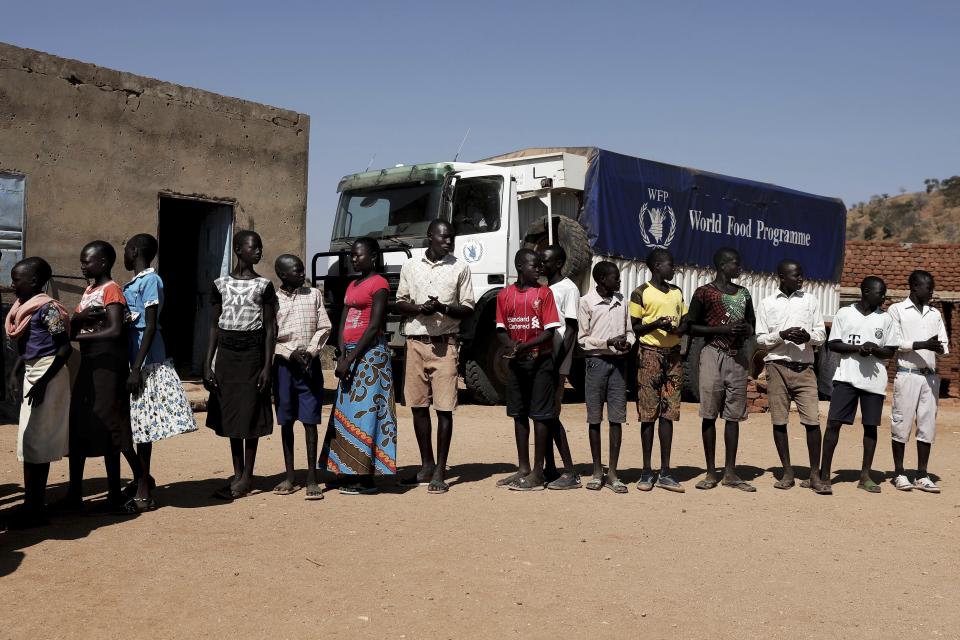 FILE - In this Jan. 9, 2020 file photo, children wait in line to receive aid during a visit organized by The World Food Program (WFP) at Koge School, in the conflict-affected remote town of Kauda, Nuba Mountains, Sudan. The World Food Program won the Nobel Peace Prize on Friday, Oct. 9 for its efforts to combat hunger amid the coronavirus pandemic, recognition that shines light on vulnerable communities across the Middle East and Africa that the U.N. agency seeks to help, those starving and living in war zones that may rarely get the world’s attention.(AP Photo/Nariman El-Mofty, File)