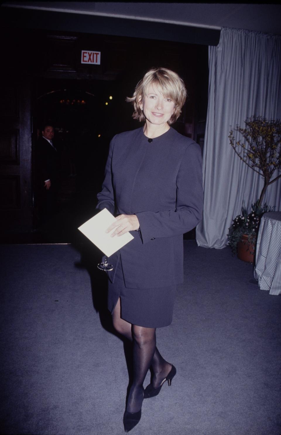 Stewart holding a drink in 1990.